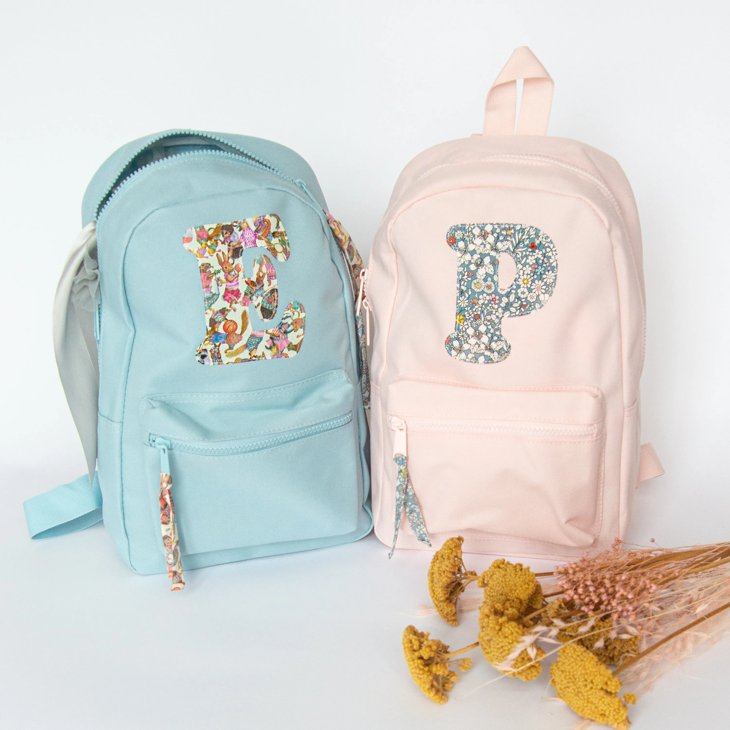 Pale pink initial backpack