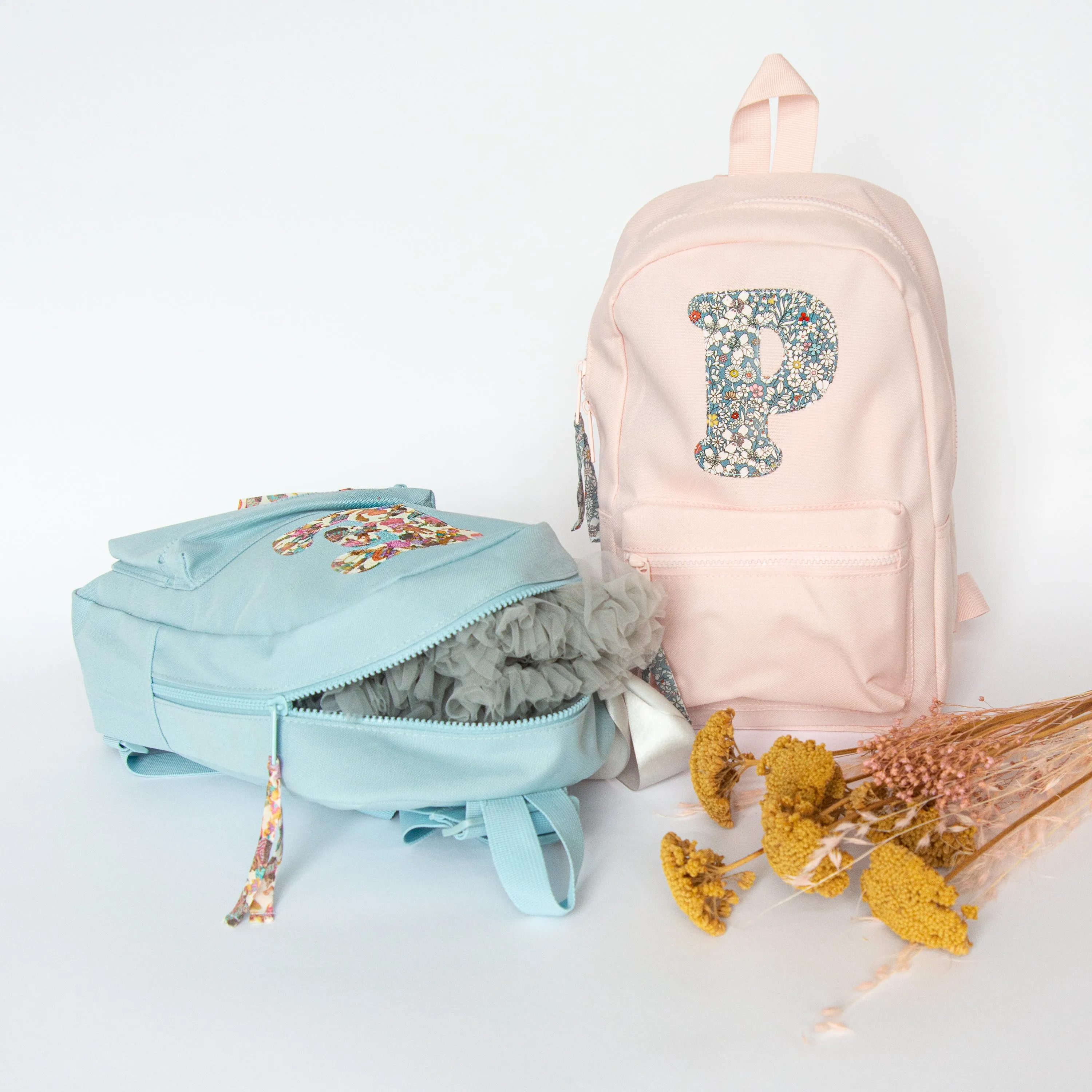 Pale pink initial backpack