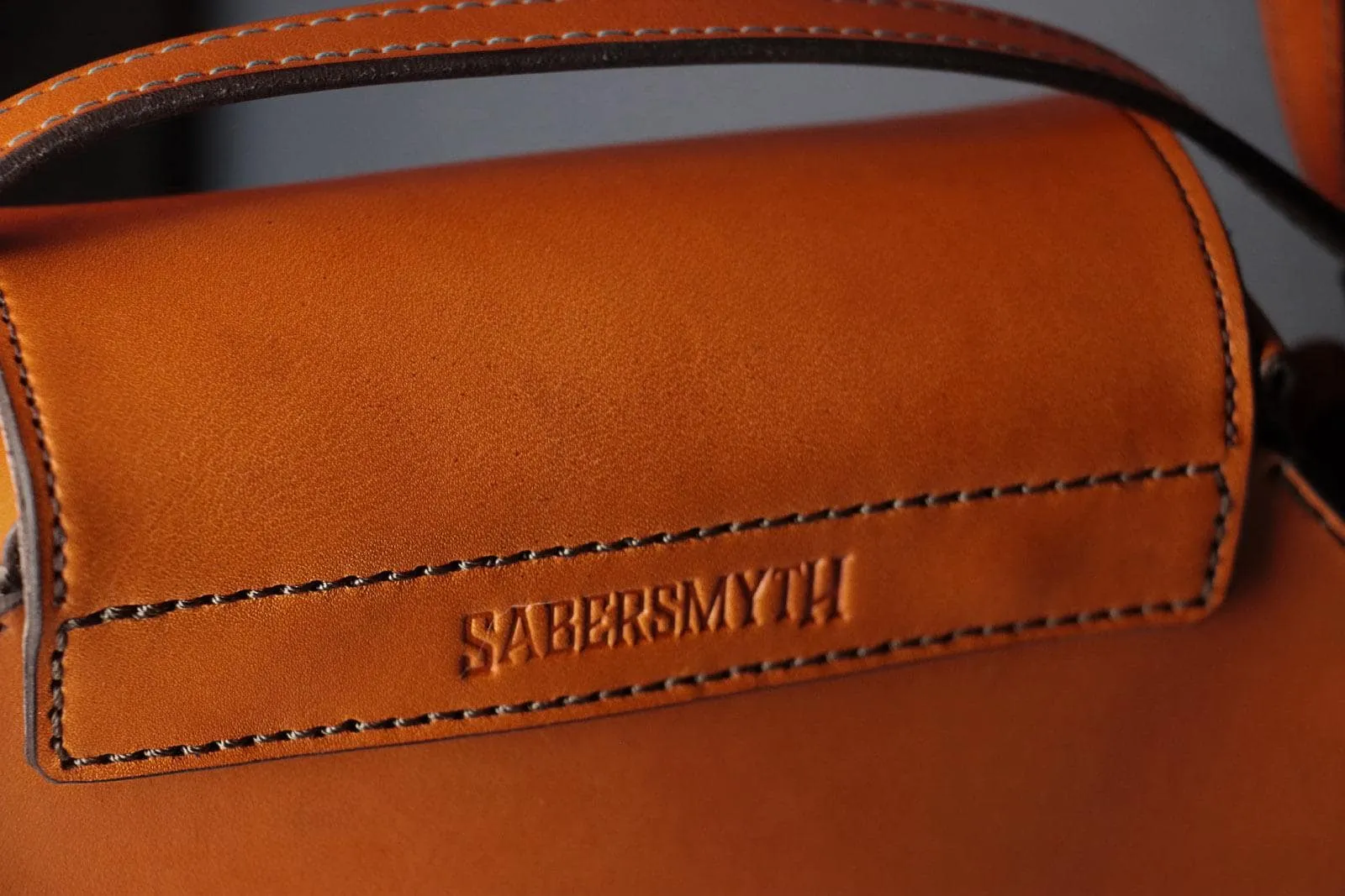 Sleek Cognac Bat Crossbody Handbag