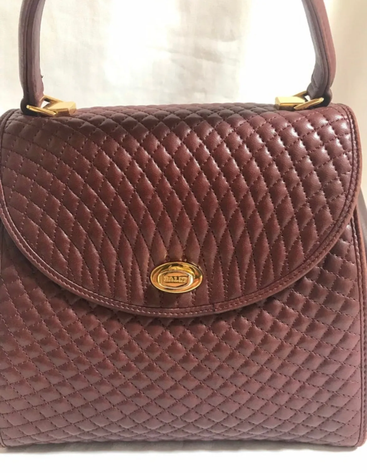 Vintage BALLY wine brown quilted lambskin handbag with golden logo turn lock closure. 050425r1